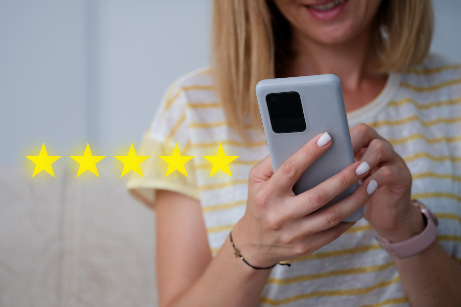 Woman leaving a five-star review from her smartphone