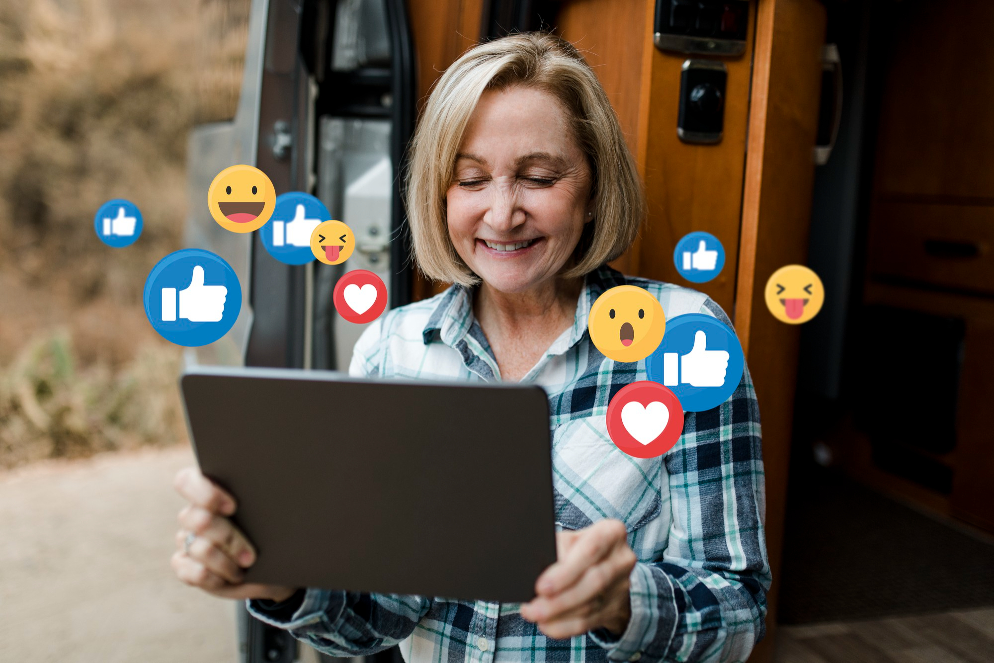 A woman happily engaging with a tablet, surrounded by floating social media reaction emojis (likes, hearts, expressive faces), illustrating interaction and engagement relevant for facebook posts ideas for restaurant.
